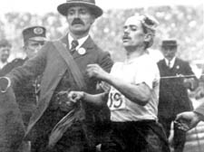 Italian Dorando Pietri being helped over the marathon &shy;finishing line &ndash; to disqualification &ndash; by official Jack Andrew