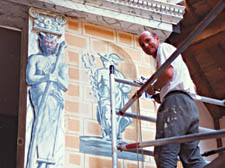 Michael May painting a set at the Globe Theatre