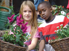 Catherine Clackson-Courquin, 8, and Mayokun Braithwaite, 7, with hanging baskets in the Westminister in Bloom competition