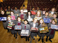 Students from Grey Coat Hospital School with some of the presents they have packed and wrapped this Christmas