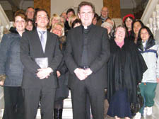 Father David Barnes with members of his congregation and others who objected to the scheme at Camden Town Hall