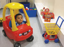 Play time: Qasim Malik, 2, gets to grips with the new toys