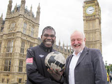 Homeless footballer Eric Mvale with his MP Frank Dobson outside the Houses of Parliament