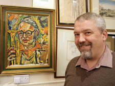 Colin Smith of Hampstead Art Auctions with the portrait of Humphrey Lyttelton