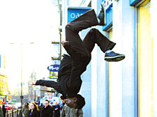 Student Chima Akenzua performs a wall flip on Upper Street in Islington