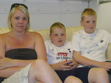 Baylie Fennelly, 9, centre, with his mother Lisa and older brother Connor, 11