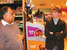 Axel Landin discusses the issue with shopkeeper Dilip Patel