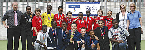 Winners Churchill Gardens Youth Club, in blue, and runners-up Isledon Wolves, with representatives of the sponsoring organisation Partners for Improvement in Camden
