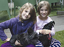 Animal magnetism: six-year-old twins Hannah and Isabel Klug with Simba the Lionhead rabbit and Angus the Scots Dumpy cockerel