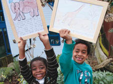 Tyler Mulcare, 5, and Cassi Konneh, 5, with animal pictures drawn by children in Harare