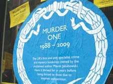 A sign in the window of Murder One blames the internet for its closure